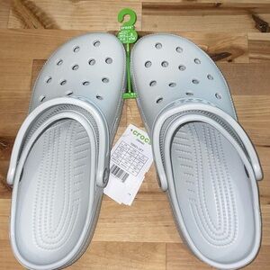 Brand new light blue/gray Crocs. Classic Clog. Men’s size 8, Women’s: size 10.